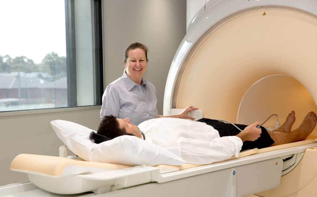 Patient being prepared by radiographer for an MRI scan at Imaging Associates.